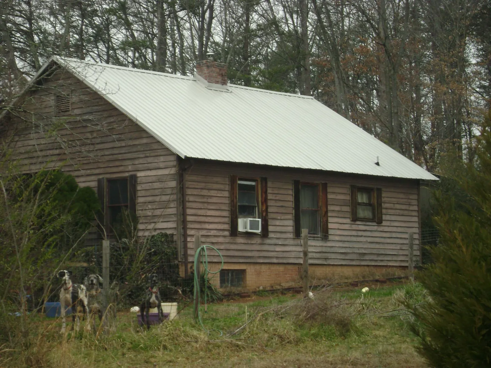 White metal roof on an old wood sided farmhouse, from a Metal Roof Installation job in South Dartmouth